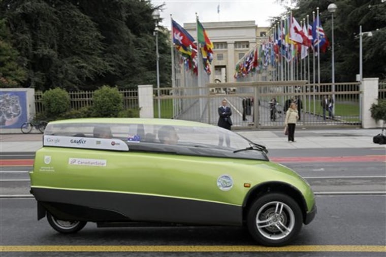 The electric vehicle of Team Trev from Australia passes in front of the European headquarters of the United Nations after starting of the Zero Race Tour, in Geneva, Switzerland, Monday, Aug. 16, 2010. Teams from Australia, Germany and Switzerland have set off from Geneva for what they hope will be the first carbon neutral race around the world. Participants are using custom built two-seater electric vehicles that will be charged from regular power outlets along the way .The race set up by Swiss inventor Louis Palmer will pass through 150 cities including Berlin, Moscow, Shanghai, Los Angeles and Cancun before returning to Geneva in January after 18,642 miles (30,000 kilometers) on the road.(AP Photo/Keystone/Salvatore Di Nolfi)